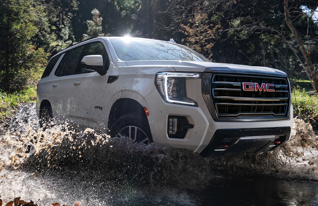 2025 GMC Sierra 1500 driving through muddy water