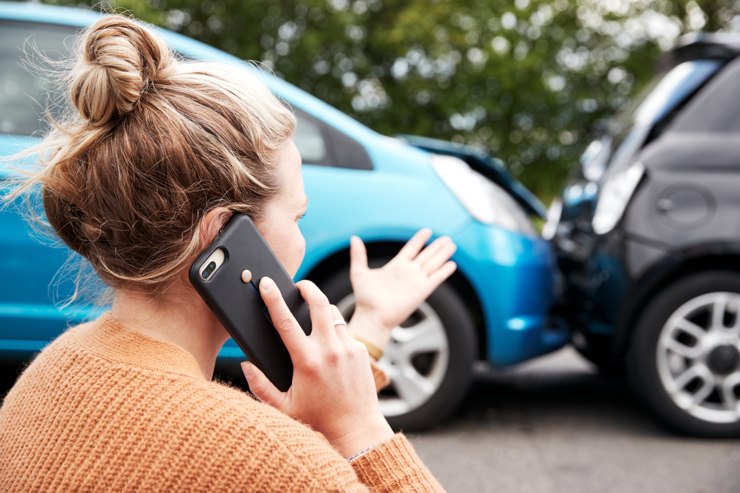 a woman on the phone calling about a car accident