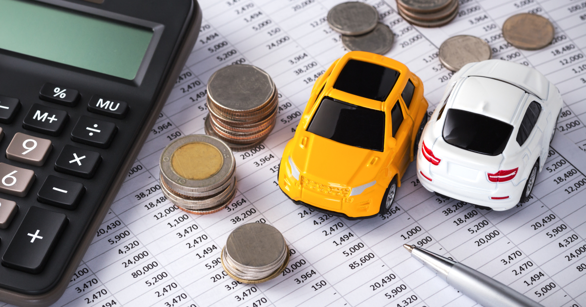 car financing a pair of toy cars with coins and calculator