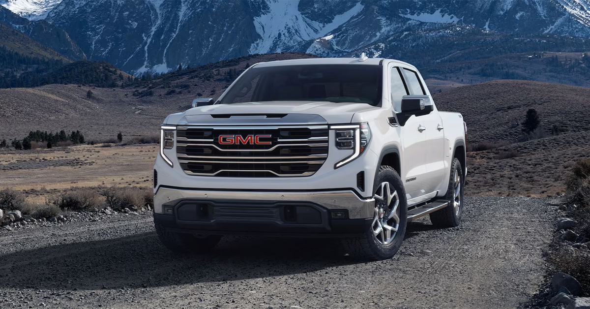 2025 GMC Sierra 1500 Truck parked in front of mountains on a gravel road