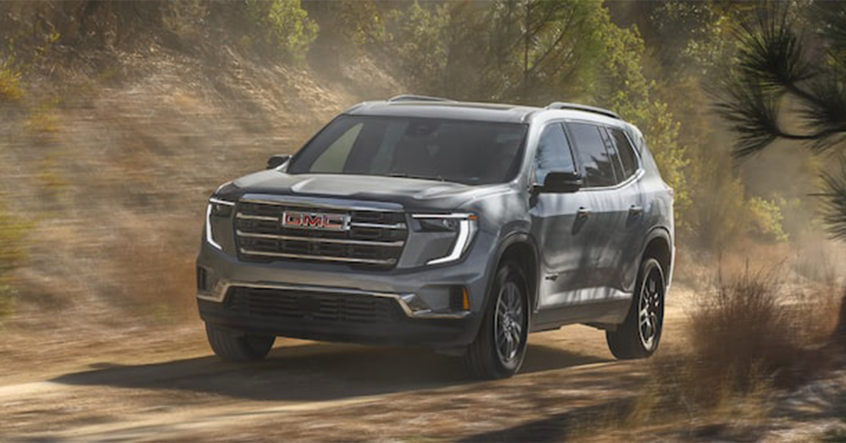 2025 GMC Acadia driving on a country road
